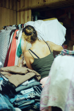 Female organizing clothes in a sewing atelie