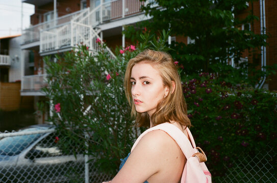 Young Woman with a pink backpack by Garden Roses
