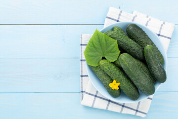 Cucumbers with leaves on wooden background,top view