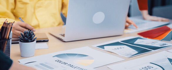 A modern workspace scene showcasing vibrant color palettes, laptops, and design graphics. This image captures the essence of teamwork and creativity in a professional setting. SACTR © InfiniteFlow