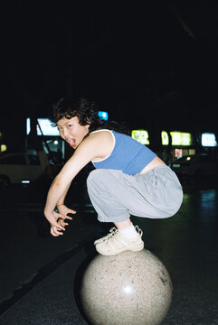 Woman roaring on a concrete sphere