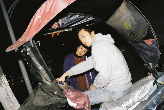 Couple on a motorcycle looking at camera