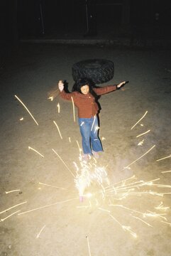 Woman jumping at an explosion of a firecracker with joy