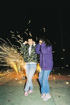 Chinese couple amidst firecrackers 