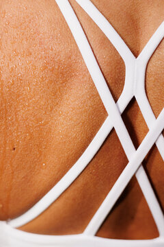 Close-up Athletic back of sweaty back in white sportswear straps