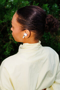 Close-Up of Woman from Behind Wearing Earphones