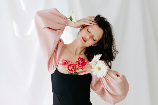 Dreamy woman with tulips and daisies
