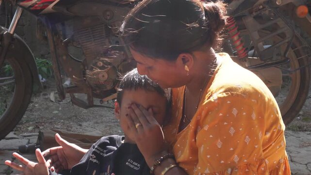 A mother safely apply baby face cream to her child to keep skin hydrated and protected