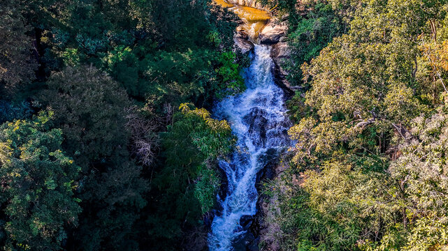 Aerial Mae Sae Waterfall cascading through jungle Chiang Mai Thailand