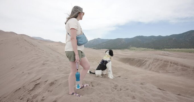 This is a shot of a Lady and her Dog at the Great Sand Dunes