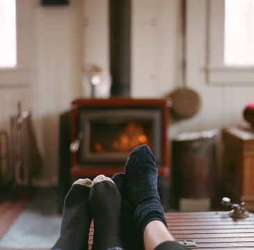 Feet warming near the wood stove.