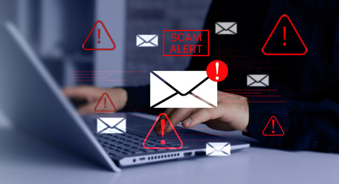 Businessman typing on laptop with warning email icons. Spam email message on digital screen. Email security and virus spam alert in email.  Scam alert. 