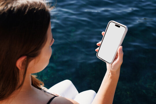 Mockup Woman Using Phone with Blank Display Near Sea View