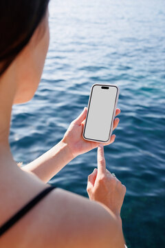 Woman Touching Smartphone with White Screen by Sea. Mockup