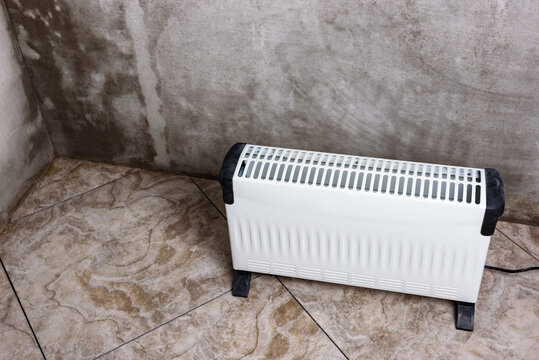 Modern portable electric heater, heating the basement. Drying the walls of a damp room.