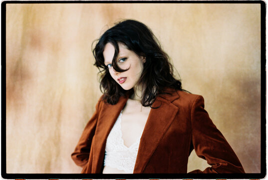 Woman with tousled hair and velvet jacket