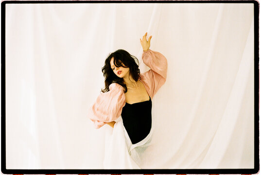 Graceful floral pose among flowing fabrics