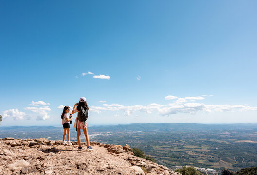 Kids taking photos with camera. Montserrat Catalonia mountain hike