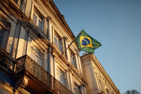 Historic brazilian building with national flag at sunset