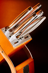 Kitchen tools stand in wooden holder ready for cooking tasks and food preparation processes