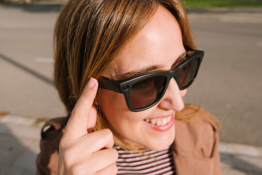 Woman activating smart glasses