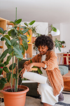 Woman waters houseplants
