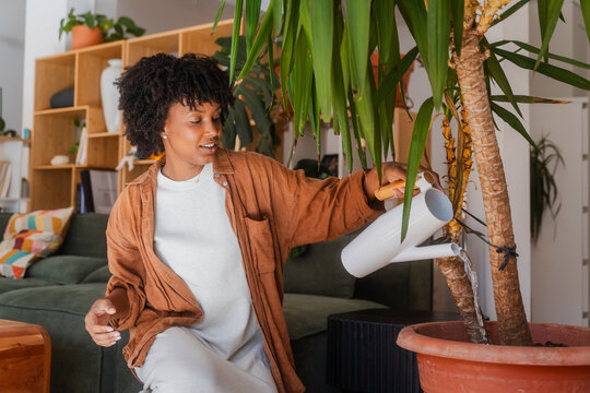 Woman waters houseplants