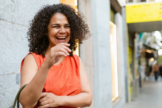 Laughing Woman Enjoying a Sunny Day in the City Street
