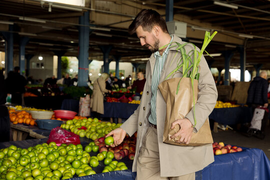 portrait of a young man at a vegetable market