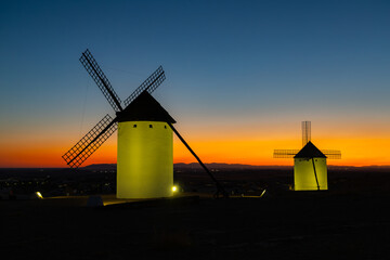 Campo de Criptana windmills standing against colorful sunset sky