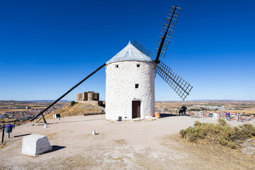Consuegra windmill and La Mancha castle on a sunny day