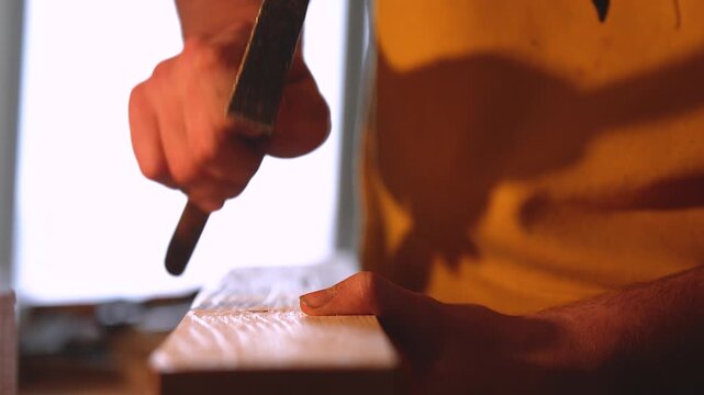 Hammer hitting wooden beam close up with loud thumping sound ASMR
