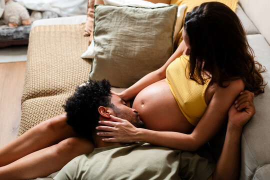 Intimate Moment of Expectant Parents at Home