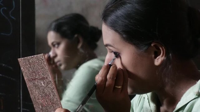 Young women usually use eyeliner to make their eyes look bigger and more attractive
