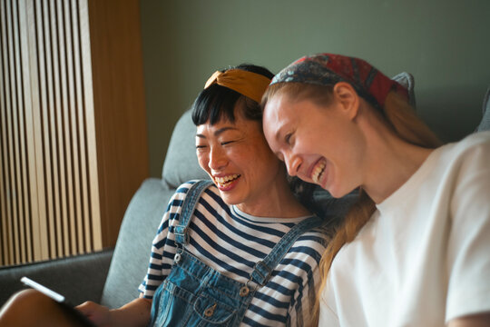 Diverse women friends laughing together enjoying a moment
