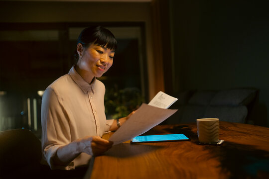 Asian woman working late at home office