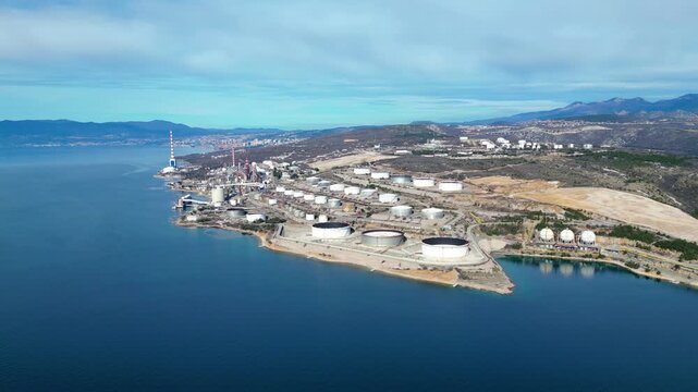 Aerial view of the INA Rijeka Refinery in Urinj, Croatia, on the Adriatic coast. Industrial complex with storage tanks by the sea.
