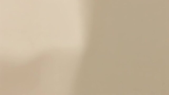 Recording camera remaining in extreme close-up to blurred beige surface, capturing soft shifts