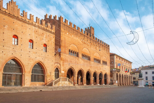 Medieval brick buildings with crenellated roofs and Gothic arches in Piazza Cavour, Rimini, Italy. Palazzo dell Arengo and Palazzo del Podesta in old town square. Italian architecture