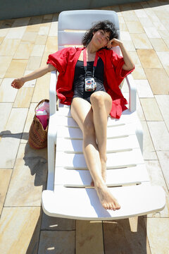 Tanning Under the Sun by the Pool in Style
