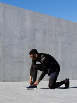 The athlete ties his shoelaces