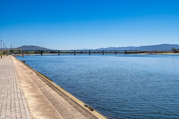 Obraz premium The Gustave Eiffel Bridge over the river Lima in Viana do Castelo in Portugal. Panoramic cityscape view of Viana and the Marina.