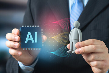 Naklejka na ściany i meble An AI microchip and a gray robot figurine. The creation of autonomous assistant robots powered by AI and neural networks. Smart automation and future robotics development concept.