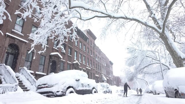 couple dig out their car during a snow storm in Brooklyn
