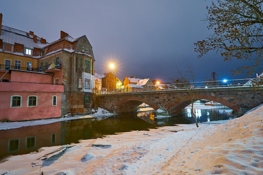 Lidzbark Warminski, Poland - february 17, 2026 - Historic stone bridge over the Lyna River in winter