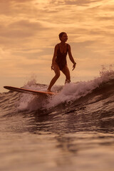 Sunset Woman Surfing On Longboard Riding Smooth Crest, Warm Golden Light, Calm Balance And Relaxed Stance