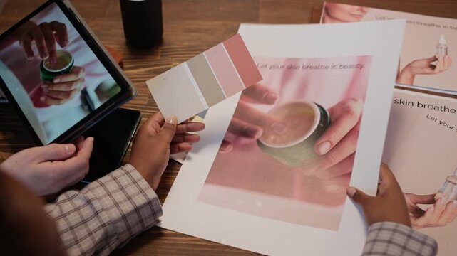 High angle shot of unrecognizable photographer, designer and producer gathering together to discuss color palette, photo references and plan of upcoming photo shooting