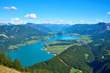 Fototapeta premium Breathtaking panorama of Lake Wolfgang facing Strobl, taken from the summit of Mount Zwölferhorn in the Salzkammergut region, Austria.