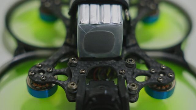 Close-up shot of FPV drone propellers working at steady speed. Detailed rotor motion, stabilized motor performance and active electronic flight system on surface. High quality 4k footage