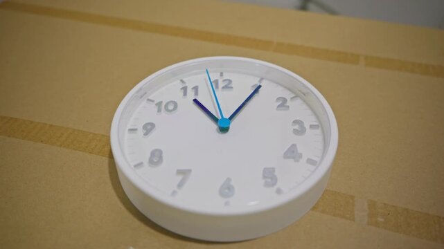 Wide shot of a wall clock with moving second hand. Continuous ticking motion illustrating passage of time in everyday interior setting. High quality 4k footage